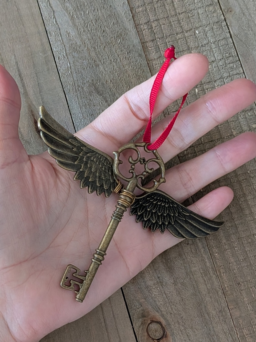 Vintage Brass Winged Key Ornament with Red Ribbon